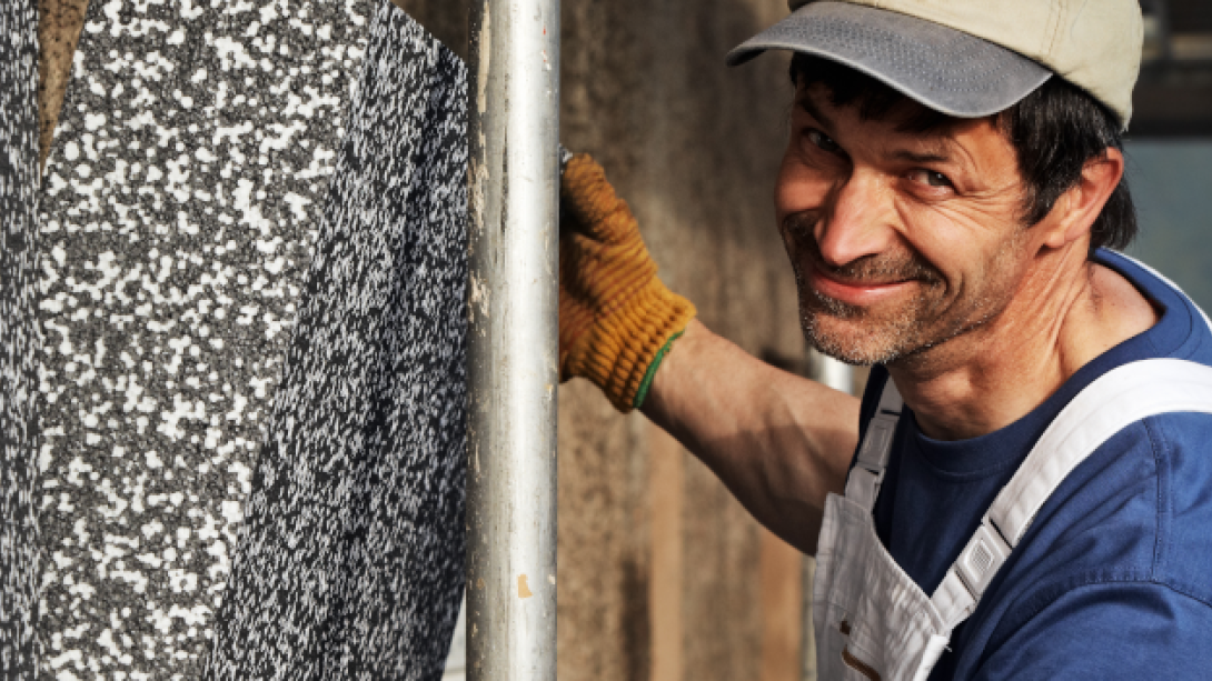 Handwerker bringt Wanddämmung an